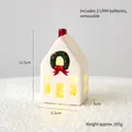 White ceramic Christmas house with red chimney, green wreath and warm internal LED light - Church Cottage B