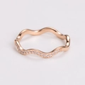 Detail of rose gold wave ring featuring micro-pave white cubic zirconia accents - US 5 / Rose Gold