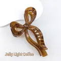 Detail of jelly caramel bow hair claw clip made of translucent resin with gold spring - Jelly Light Coffee
