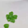 Polished 2cm green quartz crystal heart stones set on a clean white background - Fruit Green