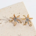 Macro shot of two-tone irregular floral earrings with polished gold and silver finish - ES2739 Irregular Flower Star
