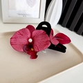 Elegant red orchid hair claw clip with faux pearl detail and realistic floral petals - Claw Clip Crimson