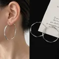Detailed view of silver twisted hoop earrings with a 5cm diameter Mobius-inspired design - Large Silver Hoop (36#)