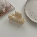 Close-up of a large cream zebra marble acetate hair claw clip on a minimalist desk - Large Square Claw / Beige