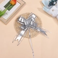 Close-up of matte silver snow yarn ribbon bow with metallic luster for gift packaging - Silver