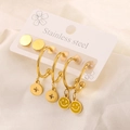 Macro shot of 18K gold plated stainless steel earring set with enamel smiley face charms - 3 Pairs Smiley Star Set