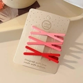 Three-piece pink candy-colored hair clip set on a handmade display card with soft lighting - Pink Gradient Cross Set