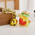 Cute yellow dragon keychain holding a red carp with a golden bell and metal ring - Fish-holding Dragon Style