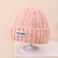 Detailed macro view of pink melange knit texture and embroidered happy face logo patch - Kids 3-10 Years (Stretchy) / Pink