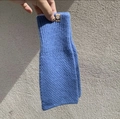 Guantes calentadores de muñeca azules de punto frente a una pared rústica con textura - Punto de Musgo-Azul