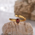 Macro detail of the golden textured open ring featuring a red pear-cut gemstone - Natural Garnet Snake Shape Ring LR383