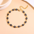 Detail of adjustable gold-tone evil eye bracelet with black beads and lobster clasp - Black Gold