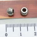 Silver Tibetan beads with sun patterns and ruler showing 1cm diameter measurement - Small Sun Spacer Bead