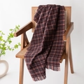 Soft dark brown plaid scarf with fringe tassels draped over a wooden chair - Berry Pink