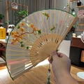 Suzhou silk embroidery folding fan featuring yellow flowers, butterfly motifs and silk tassel - 2026 Hot Selling Item - Suzhou Embroidery Fan - Ginkgo Butterfly