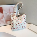 Beige corduroy tote bag featuring red strawberry patterns and dual top handles - White