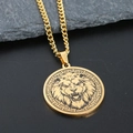 Detail of a golden lion head pendant with a Greek key border on a dark stone slab - Gold Lion