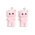Close-up of pink flocked resin cat charms with metal hanging rings for DIY crafts - 17*38mm / Pink Cat