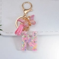 Pink resin letter N keychain with butterfly sequins and a stylish suede tassel - Letter N