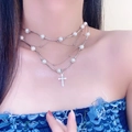 Three-layer pearl necklace featuring a sparkling cross pendant on a female model - Three-Layer Stacked Cross Artificial Pearl Necklace (X4137)
