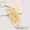 Realistic PVC soda biscuit keychain showing dimensions 9cm by 4.3cm with metal ring - Baked Soda Biscuit Keychain