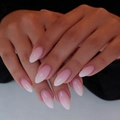 Pink and white ombre almond press-on nails with high gloss finish on model hand - Pink White Elegant Almond (AW453)