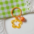 Colorful star acrylic keychain with yellow star pendant and orange bell accessory - Transparent Orange