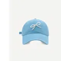 Detail of light blue cotton baseball cap featuring a white faux pearl bow decoration - M (56-58cm) / Sky Blue