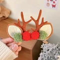 Close-up of reindeer antler hair clip with brown horns and red green plush balls - Brown Antlers with Red & Green Pom Poms Pair