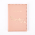 Close-up of pink PU leather passport holder with gold Adventure Begins lettering - Pink