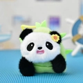 Close-up of a cute plush panda pendant with a green bamboo shoot hat detail and flower. - 12cm / Round-Eyed Panda in Bamboo