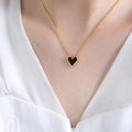 Golden chain necklace with a black heart pendant featuring beaded edges worn by model - Gold Black Acrylic Heart Necklace (P436) / 40+5cm