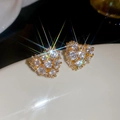 Macro shot of 18k gold plated heart studs with sparkling cubic zirconia starburst effect - 18K Gold Plated / Gold