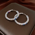 Close-up of circular hoop earrings with multi-colored cubic zirconia on dark satin - 24# Silver Row Pave Rainbow Zircon Hoop Earring