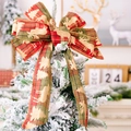 Red and green plaid Christmas bow with golden reindeer print on a snowy tree top - Christmas Bow Style G (Red Green Plaid/Gold Tree)