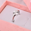 Detailed view of a silver sunburst engraved ring placed in a pink jewelry gift box - US 5 / Silver