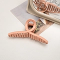 Macro detail of large matte hair claw clip in a soft peach-pink hue for thick hair - Cross / Orange Pink