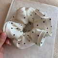 Elegant satin scrunchie featuring cream fabric with black polka dots and wavy edges - Beige Polka Dot (Ruffle Edge)