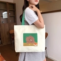 Off-white canvas tote bag featuring green handles and Line Friends Brown Bear print - Brown Bear Learning - Beige
