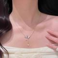 Elegant silver butterfly necklace with pearl tassel and diamond accents on a model - Butterfly Style (LI364)