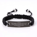 Macro detail of engraved inspirational message on black metal plate of woven bracelet - To my son always remember (From Mom)