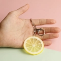Realistic PVC lemon slice keychain featuring detailed fruit texture and metal lobster clasp - Small Lemon Slice