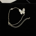 Gold butterfly bracelet with white mother-of-pearl wings and sparkling zircon stone - Shell Butterfly Bracelet