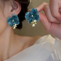Detail showing a navy blue flower earring with gold edges and a small 3D bee pendant - Silver Pin-Blue Bee Flower