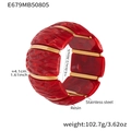 Detail showing 4.1cm width and 6cm diameter of the red resin and gold stainless steel cuff - 60mm / Red (E679)