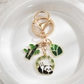 Panda and bamboo gold metal keychain with colorful enamel pendants on white surface - Panda on Back
