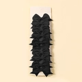 Close-up of black grosgrain ribbon bow hair clips on a beige display card - Black (4)