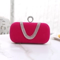 Close-up of pink velvet evening bag with U-shaped crystal fringe and round diamond clasp - Rose Red