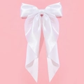 Elegant white satin oversized bow hair clip with long flowing ribbons on pink background - White