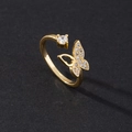 Detail of bypass ring with pavé butterfly and sparkling round diamond on black surface - Style E-Gold Butterfly & Round Zircon Link
